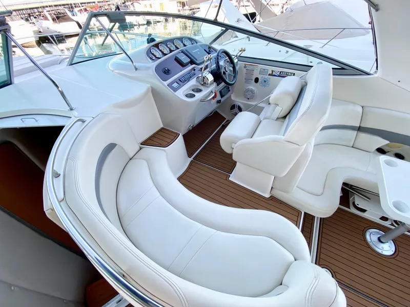 Slide: The Image of 2006 Chaparral Signature 350 yacht interior with white seating and modern dashboard. - 5
