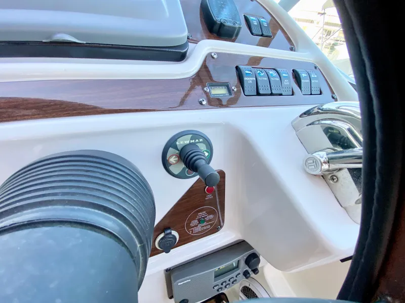 Slide: The Image of 2006 Chaparral Signature 350 boat dashboard with controls and switches. - 8