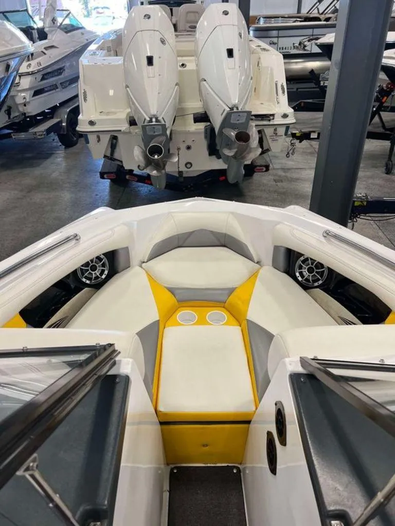 Slide: The Image of 2015 Tigé R20 boat interior with yellow and white seating in showroom. - 3