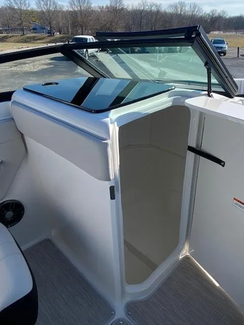 Slide: The Image of 2025 Sea Ray SPX 230 boat interior with open cabin door, showcasing sleek design. - 11