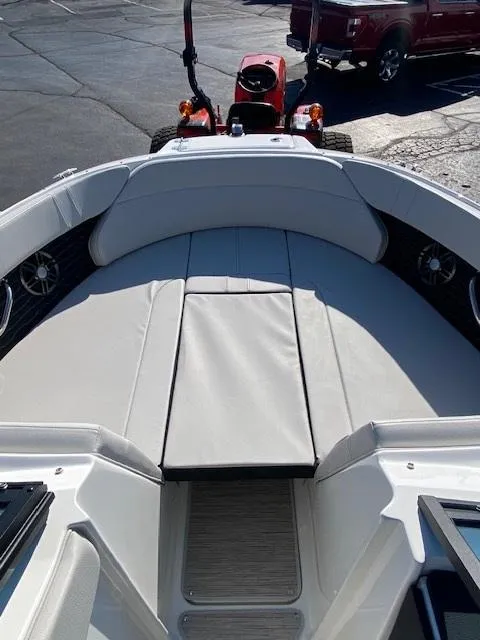 Slide: The Image of 2025 Sea Ray SPX 230 boat interior with cushioned seating and modern design. - 12