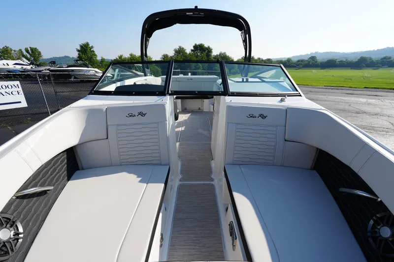 Slide: The Image of 2025 Sea Ray SPX 230 boat interior with white seating and sleek design. - 19