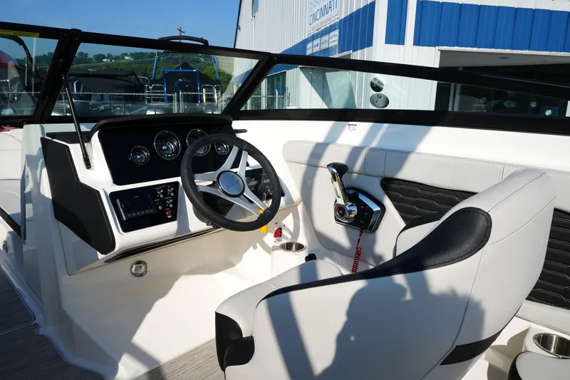 Slide: The Image of 2025 Sea Ray SPX 230 boat interior with steering wheel and control panel. - 20