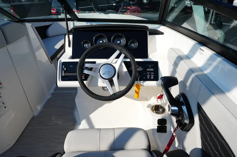 Slide: The Image of 2025 Sea Ray SPX 230 boat cockpit with steering wheel and control panel. - 21