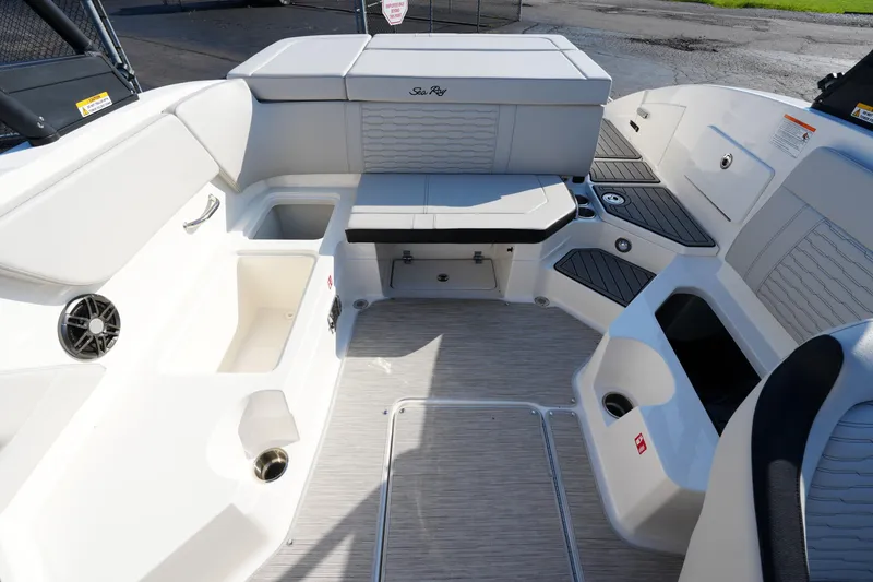 Slide: The Image of 2025 Sea Ray SPX 230 boat interior with seating and storage compartments. - 24