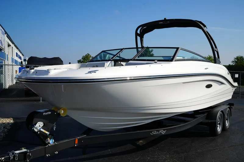 Slide: The Image of 2025 Sea Ray SPX 230 boat on trailer, sleek white design, parked outdoors. - 4