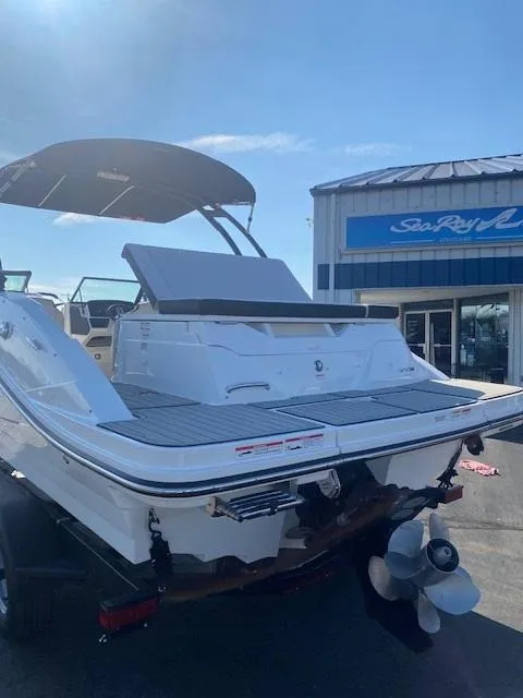 Slide: The Image of 2025 Sea Ray SPX 230 boat at dealership, rear view with swim platform. - 7