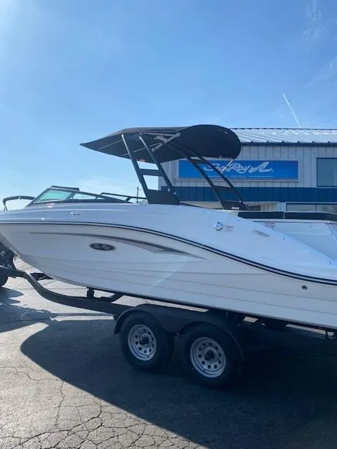 Slide: The Image of 2025 Sea Ray SPX 230 boat on trailer, displayed outdoors under clear sky. - 8