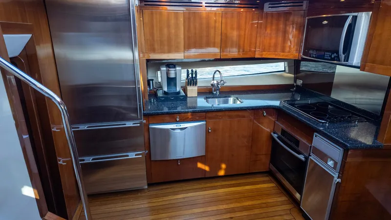 Slide: The Image of Luxurious kitchen in 2008 Savannah 54 yacht with wood cabinetry and stainless steel appliances. - 18