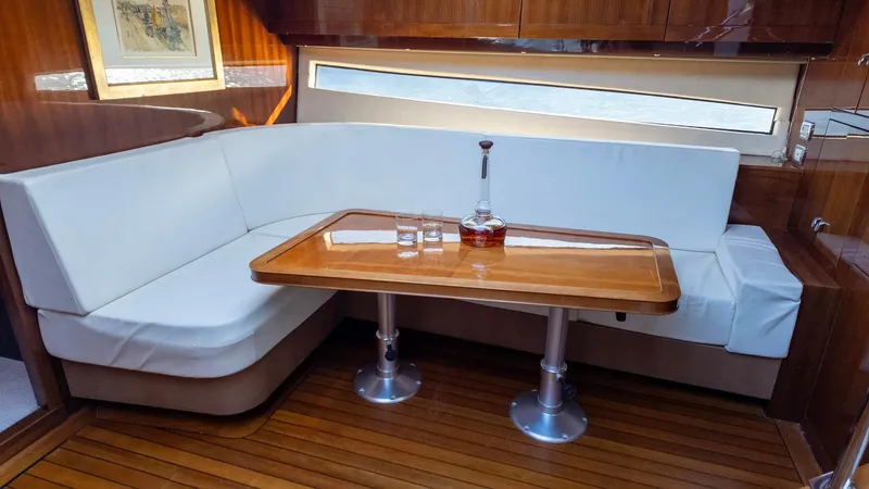 Slide: The Image of Luxurious 2008 Savannah 54 yacht interior with elegant wood table and white seating. - 19
