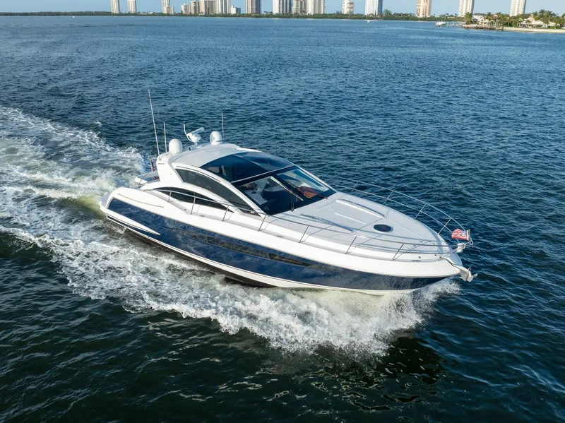 Slide: The Image of Sleek 2008 Savannah 54 yacht cruising on open water near city skyline. - 2