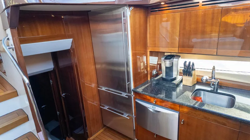 Slide: The Image of Luxurious kitchen in 2008 Savannah 54 yacht with modern appliances and wooden cabinetry. - 23