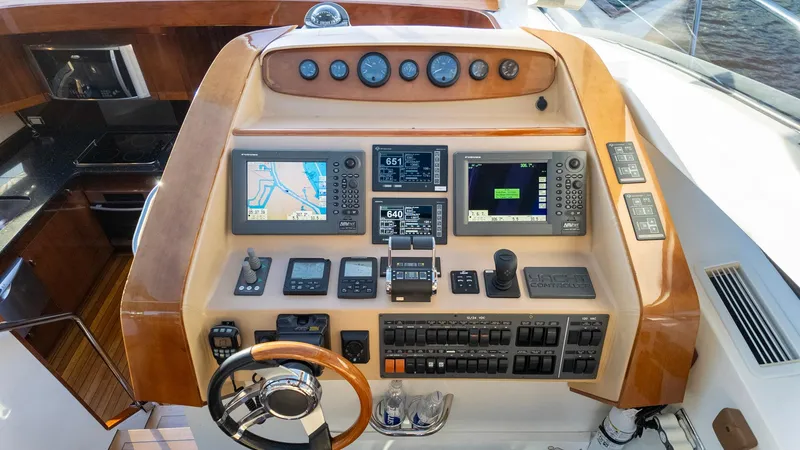 Slide: The Image of Luxury yacht control panel, Savannah 54, 2008 model, featuring advanced navigation and monitoring systems. - 28