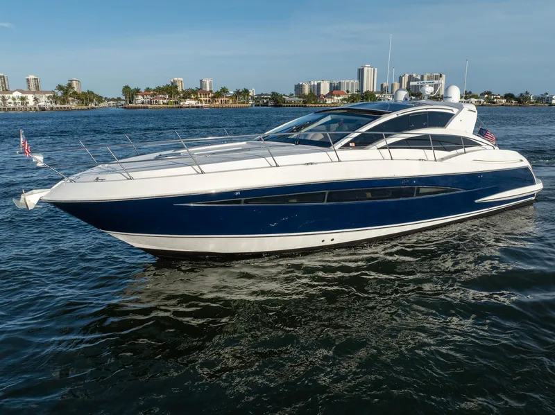 Slide: The Image of 2008 Savannah 54 yacht cruising on open water with city skyline in background. - 3