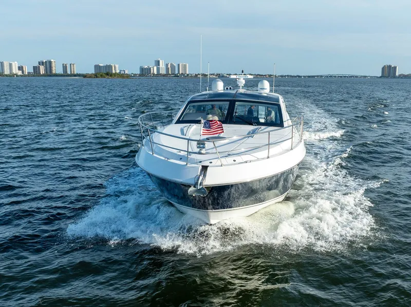 Slide: The Image of Savannah 54 yacht cruising on open water, 2008 model, with city skyline in background. - 7
