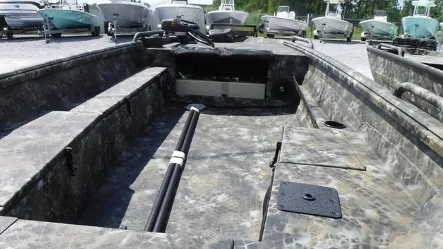 Slide: The Image of 2025 Excel Boats Viper F4 1751 interior, camo design, spacious seating, and storage compartments. - 4