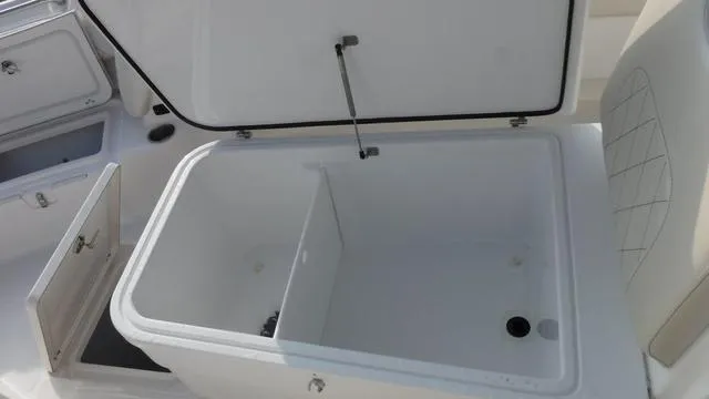 Slide: The Image of Open storage compartment on 2023 Blue Wave 2800 Makaira boat. - 12