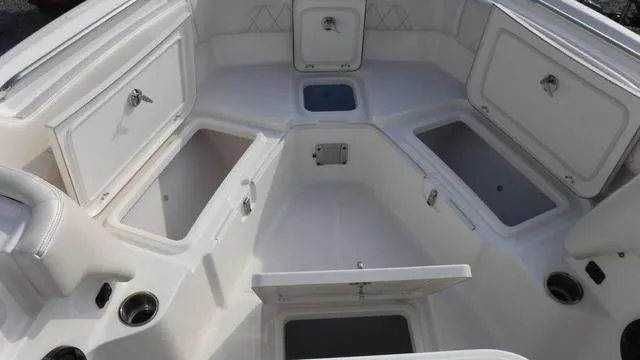 Slide: The Image of 2023 Blue Wave 2800 Makaira boat interior with multiple storage compartments. - 13