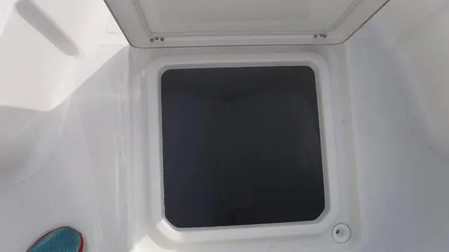 Slide: The Image of Open storage compartment on 2023 Blue Wave 2800 Makaira boat. - 14