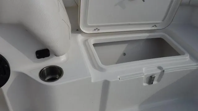 Slide: The Image of 2023 Blue Wave 2800 Makaira boat interior storage compartment and cup holder. - 16