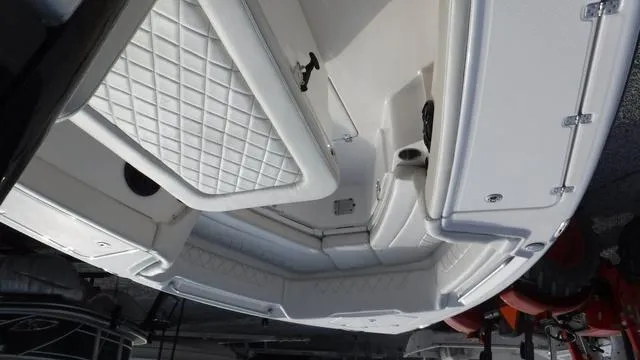 Slide: The Image of 2023 Blue Wave 2800 Makaira boat interior with cushioned seating and storage compartments. - 19