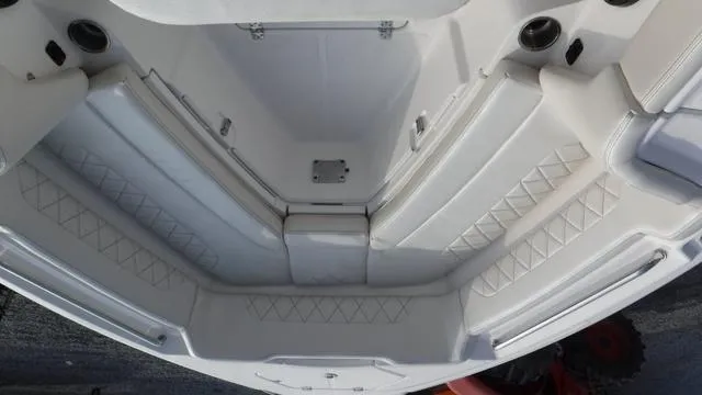 Slide: The Image of 2023 Blue Wave 2800 Makaira boat interior with cushioned seating and storage. - 20