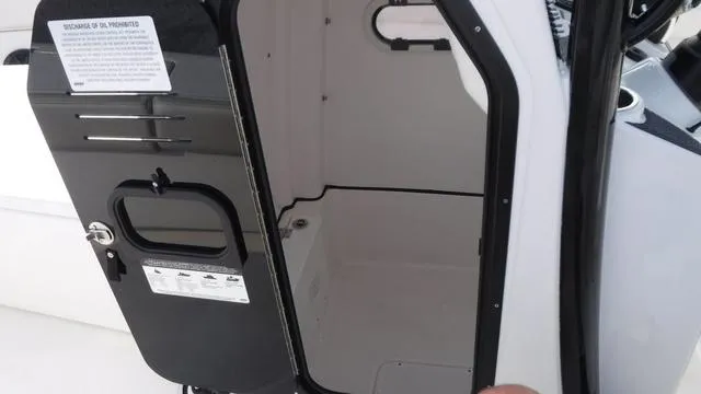 Slide: The Image of 2023 Blue Wave 2800 Makaira boat cabin interior with open door. - 25