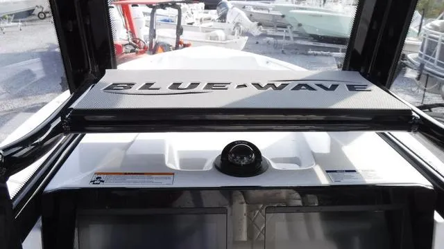 Slide: The Image of 2023 Blue Wave 2800 Makaira boat dashboard with compass and brand logo. - 30