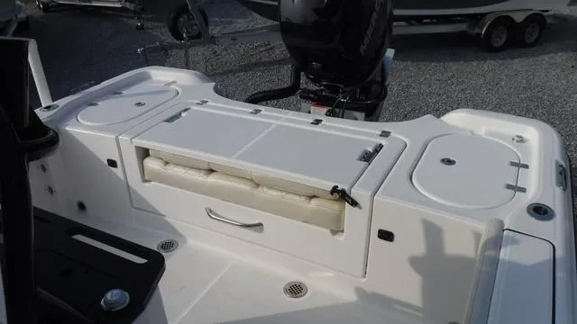 Slide: The Image of 2023 Blue Wave 2800 Makaira boat interior with storage compartments and seating. - 32