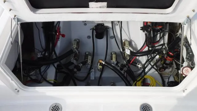 Slide: The Image of 2023 Blue Wave 2800 Makaira boat wiring and components inside compartment. - 34