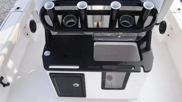 Slide: The Image of 2023 Blue Wave 2800 Makaira boat console with rod holders and storage. - 38