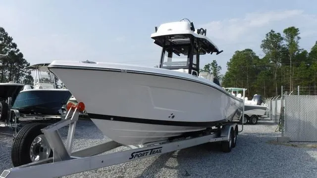 Slide: The Image of 2023 Blue Wave 2800 Makaira boat on trailer, parked outdoors. - 4