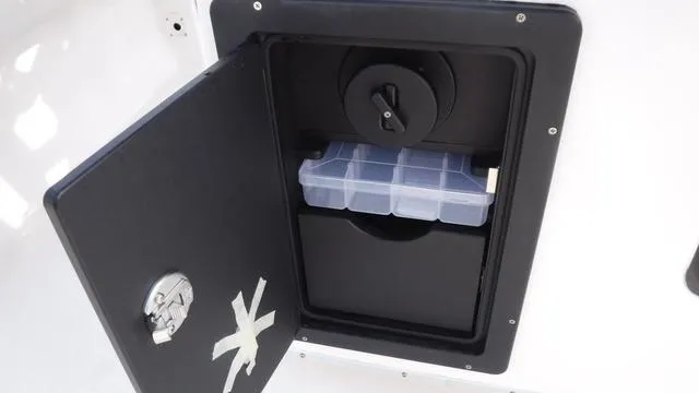 Slide: The Image of 2023 Blue Wave 2800 Makaira storage compartment with tackle box inside. - 40