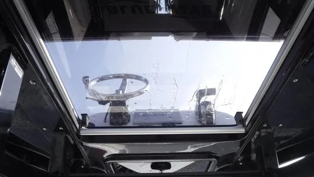 Slide: The Image of Interior view of 2023 Blue Wave 2800 Makaira boat, showcasing steering wheel and controls. - 42