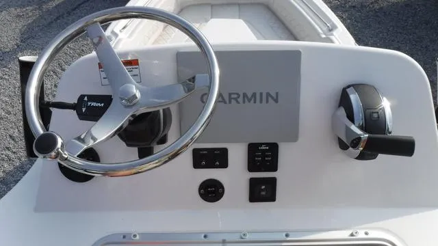 Slide: The Image of 2023 Blue Wave 2800 Makaira boat console with Garmin navigation and steering wheel. - 44