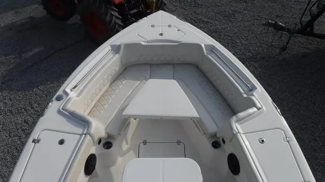 Slide: The Image of 2023 Blue Wave 2800 Makaira boat interior with cushioned seating and storage compartments. - 46