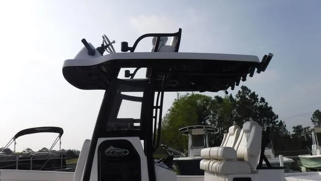 Slide: The Image of 2023 Blue Wave 2800 Makaira boat with seating and tower, outdoors under clear sky. - 6