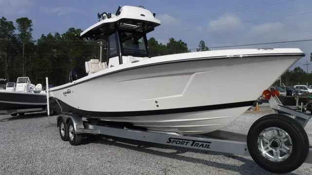 Slide: The Image of 2023 Blue Wave 2800 Makaira boat on trailer, parked outdoors. - 9