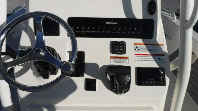 Slide: The Image of 2024 Pathfinder 2600 TRS boat dashboard with steering wheel and controls. - 11