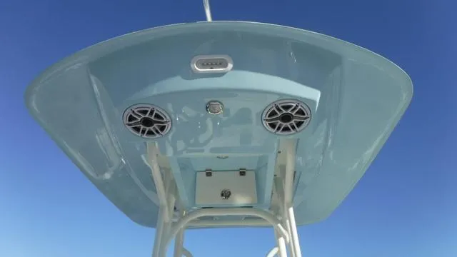 Slide: The Image of 2024 Pathfinder 2600 TRS boat top view with speakers against clear blue sky. - 13