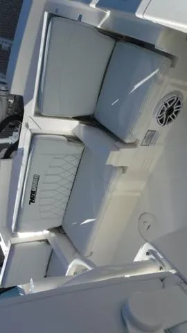 Slide: The Image of 2024 Pathfinder 2600 TRS boat interior with cushioned seating and speaker. - 15