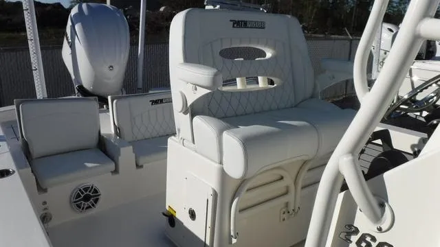 Slide: The Image of 2024 Pathfinder 2600 TRS boat interior with white seating and console. - 18