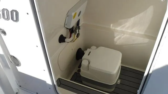 Slide: The Image of 2024 Pathfinder 2600 TRS boat interior with portable toilet and wiring. - 21