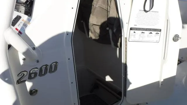 Slide: The Image of 2024 Pathfinder 2600 TRS boat cabin entrance with open door. - 22