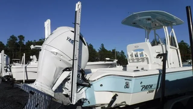 Slide: The Image of 2024 Pathfinder 2600 TRS boat with Yamaha engine, parked outdoors. - 3