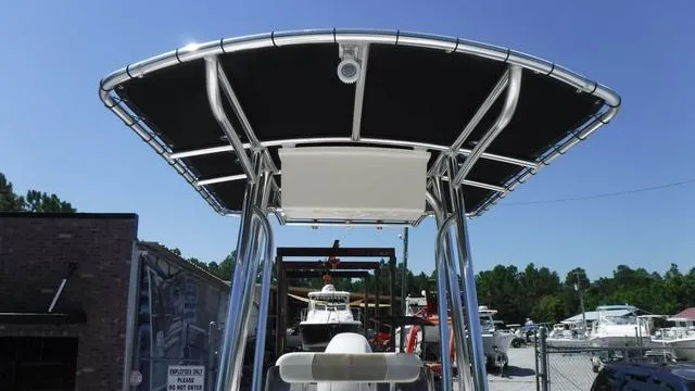 Slide: The Image of 2024 Bulls Bay 2200 boat with T-top in marina setting. - 13