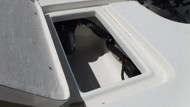 Slide: The Image of 2024 Bulls Bay 2200 boat storage compartment with visible wiring and components. - 20