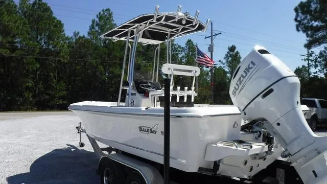 Slide: The Image of 2024 Bulls Bay 2200 boat with Suzuki engine on trailer, parked outdoors. - 3