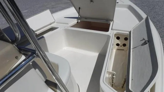 Slide: The Image of 2024 Bulls Bay 2200 boat interior with open storage compartments. - 7