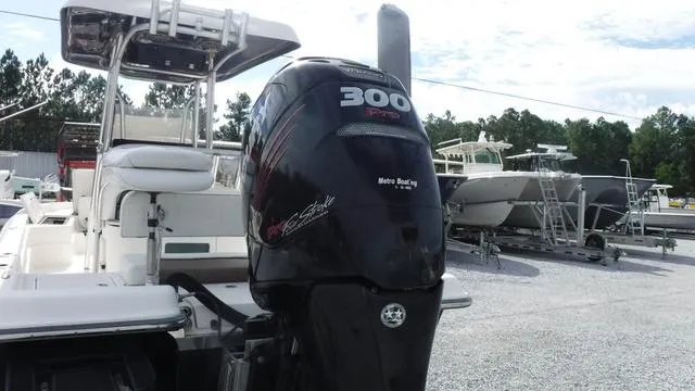 Slide: The Image of 2013 ShearWater 25 Bay boat with 300 HP engine in a marina setting. - 11